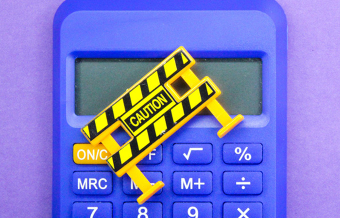 TRUE NORTH FEDERAL CREDIT UNION CALCULATOR WITH CAUTION SIGN ACROSS IT