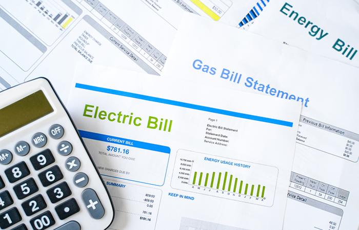 Calculator with a spread of utility bills