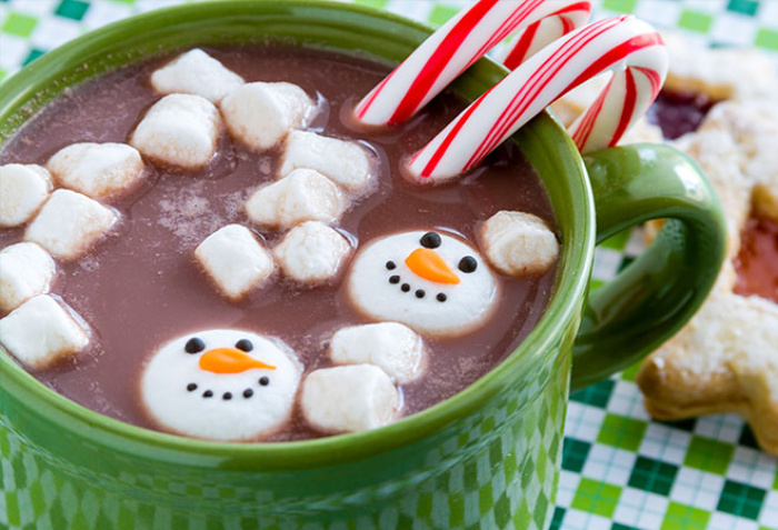 candy canes and snowmen floating in a mug of hot chocolate