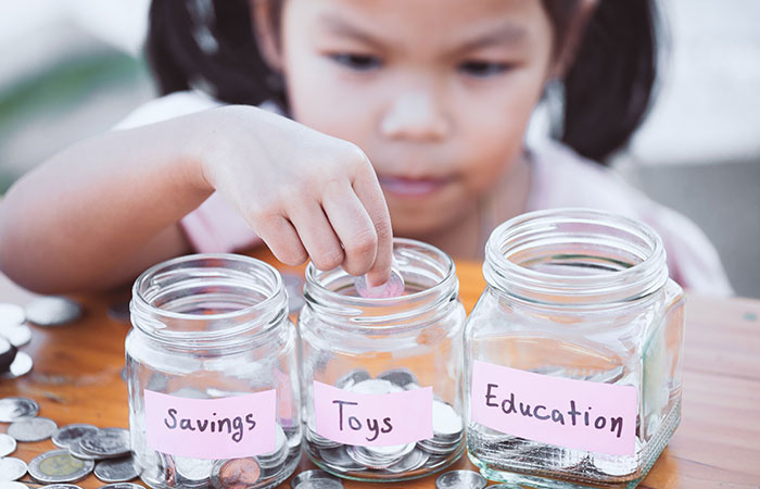 TRUE NORTH FEDERAL CREDIT UNION CHILD WITH SAVINGS JARS