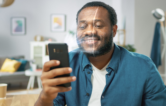 man using face authentication on his cell phone