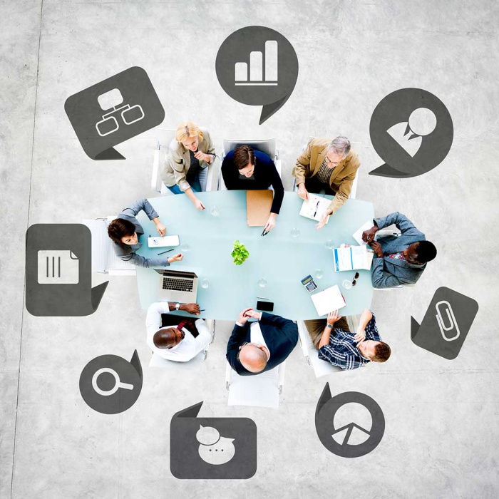 people around a conference table discussing company policies