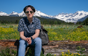 AUSTIN SITTING ON A LOG OUTSIDE JUNEAU ALASKA