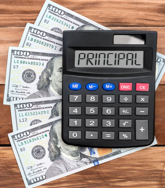 calculator with the word Principle on a spread of one hundred dollar bills on a wooden table